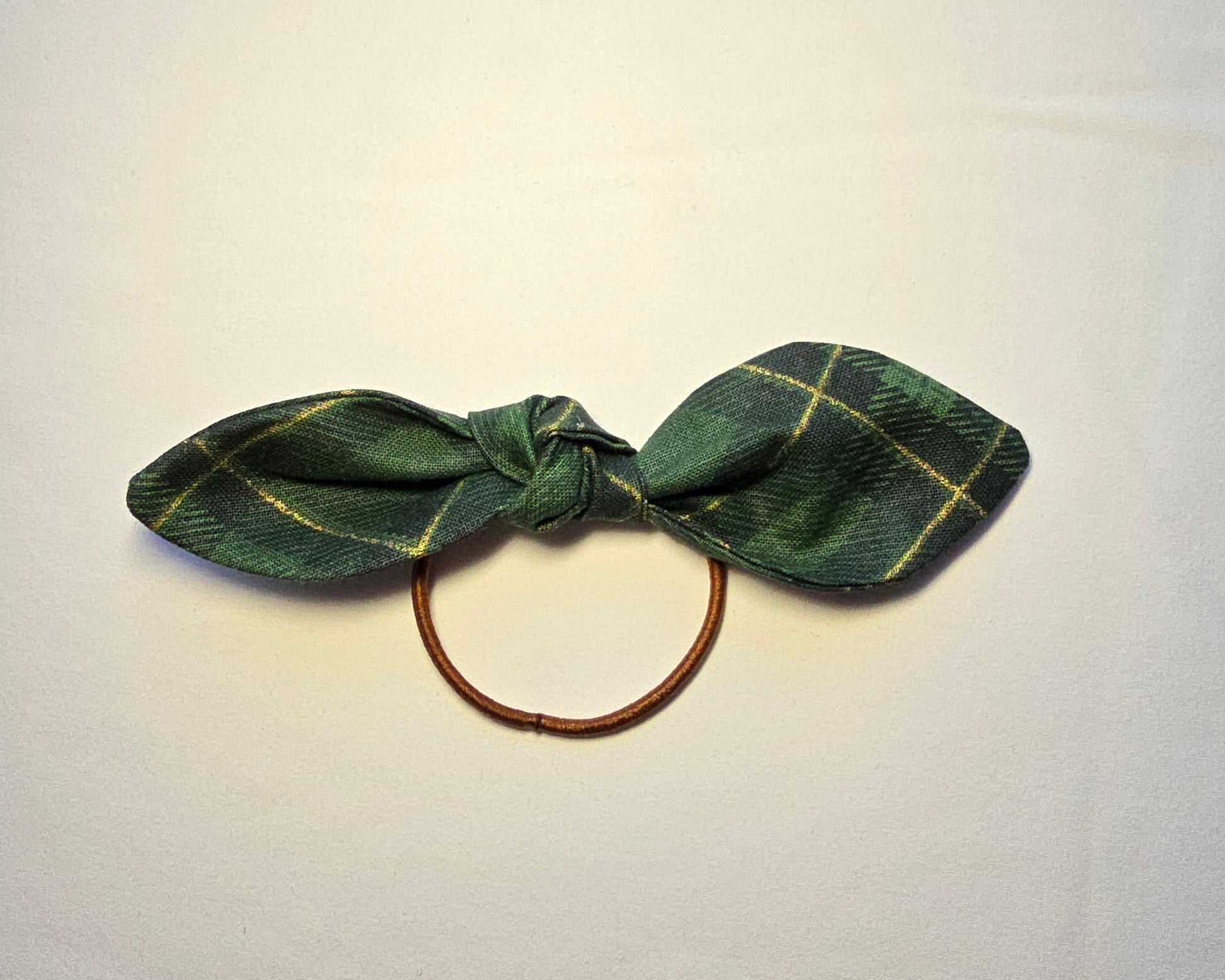 Green plaid hair tie on a white background