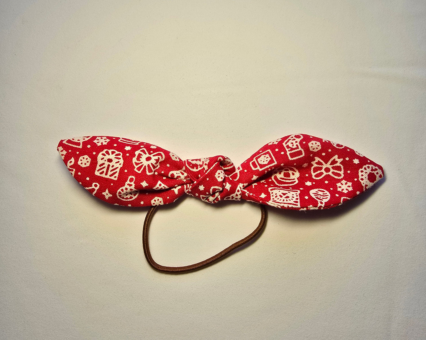 Red patterned headband on a light gray background